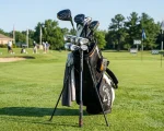 Premium Callaway mens complete golf club set in a stand bag on a practice range green