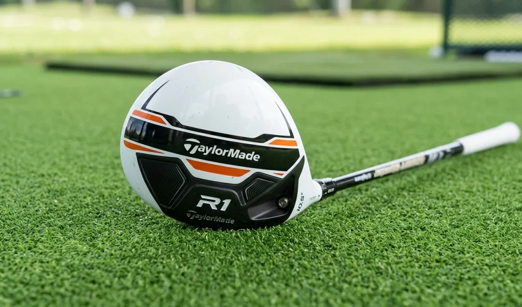 TaylorMade R1 Driver Tuning Guide: Lofts, Weights & Soles 1 TaylorMade R1 white driver head resting on green practice turf showing racing stripe graphics (AI Generated Image)